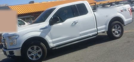 Example still of a white Ford F-150 arriving at a job site.